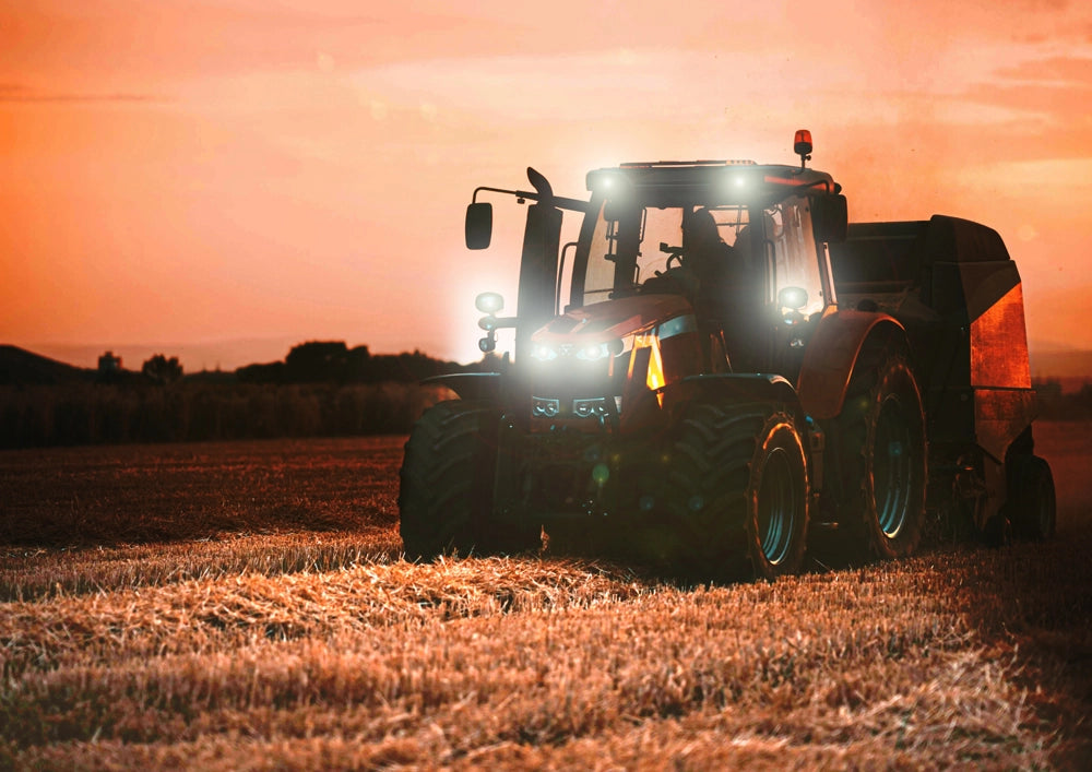 Tractor working in a field at sunset using the Noxsolis 3" LED Slim Work Light 12-24V 24W